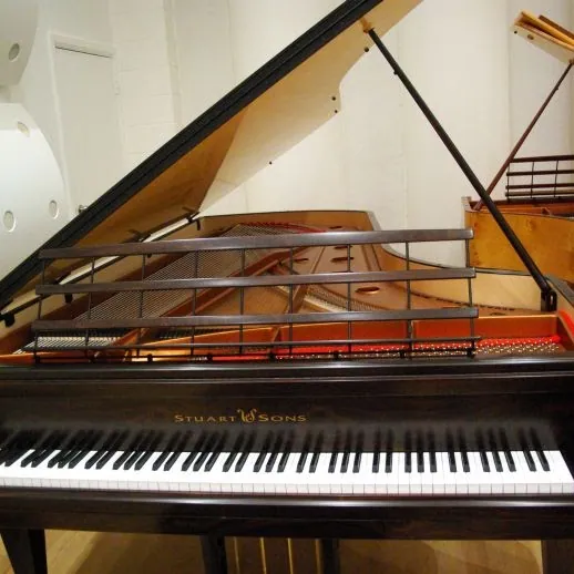 Open grand piano showing its strings and keyboard