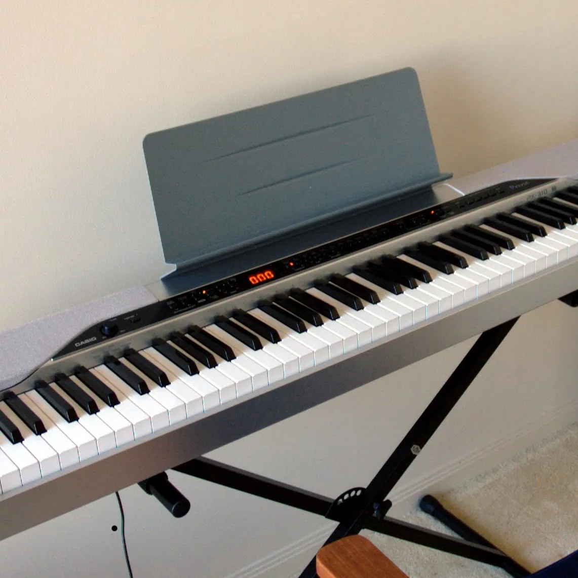 Digital piano with a music stand on a keyboard support